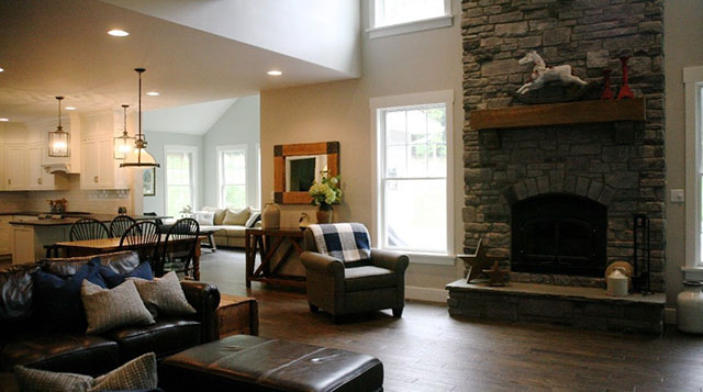custom living room with large stone fireplace