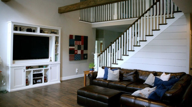 side view of custom staircase and home entertainment center in living room