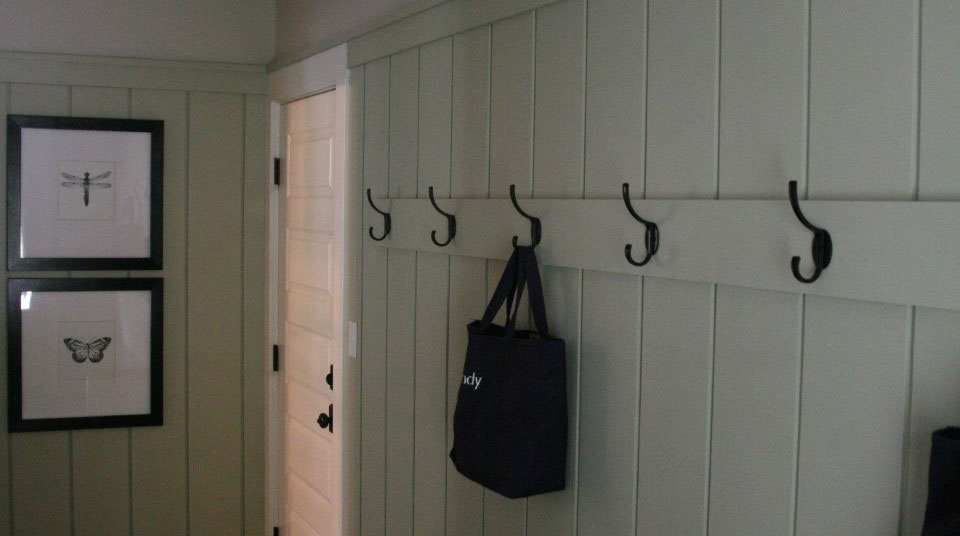 mudroom inside custom home with hooks on the wall