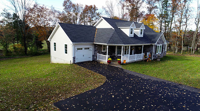 side view of attached custom garage on large home