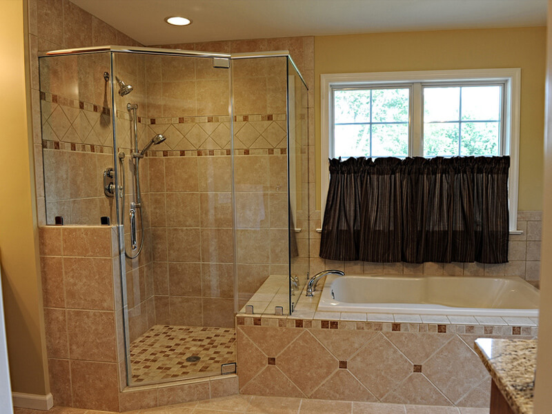 custom bathroom remodel with clear shower and bath tub