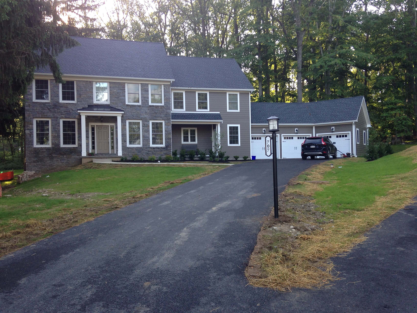 large stone home with fiber cement siding and building stone in exton