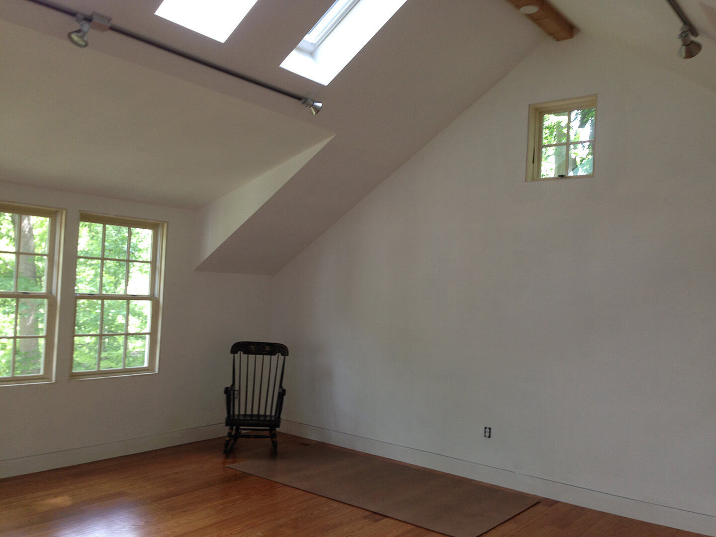 interior shot of small studio over garage with hardwood floors