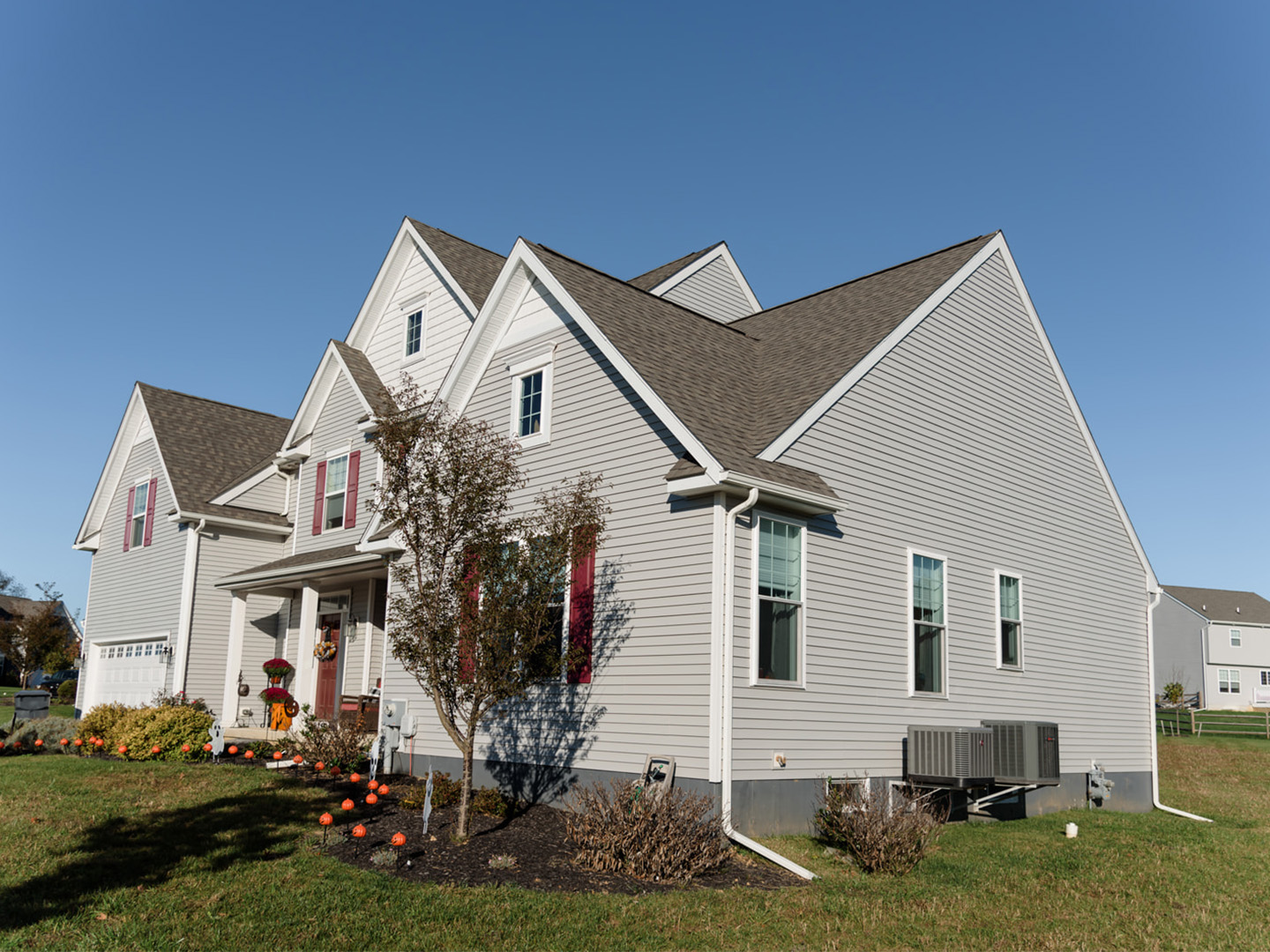 after shot of cape cod style renovation with attached garage