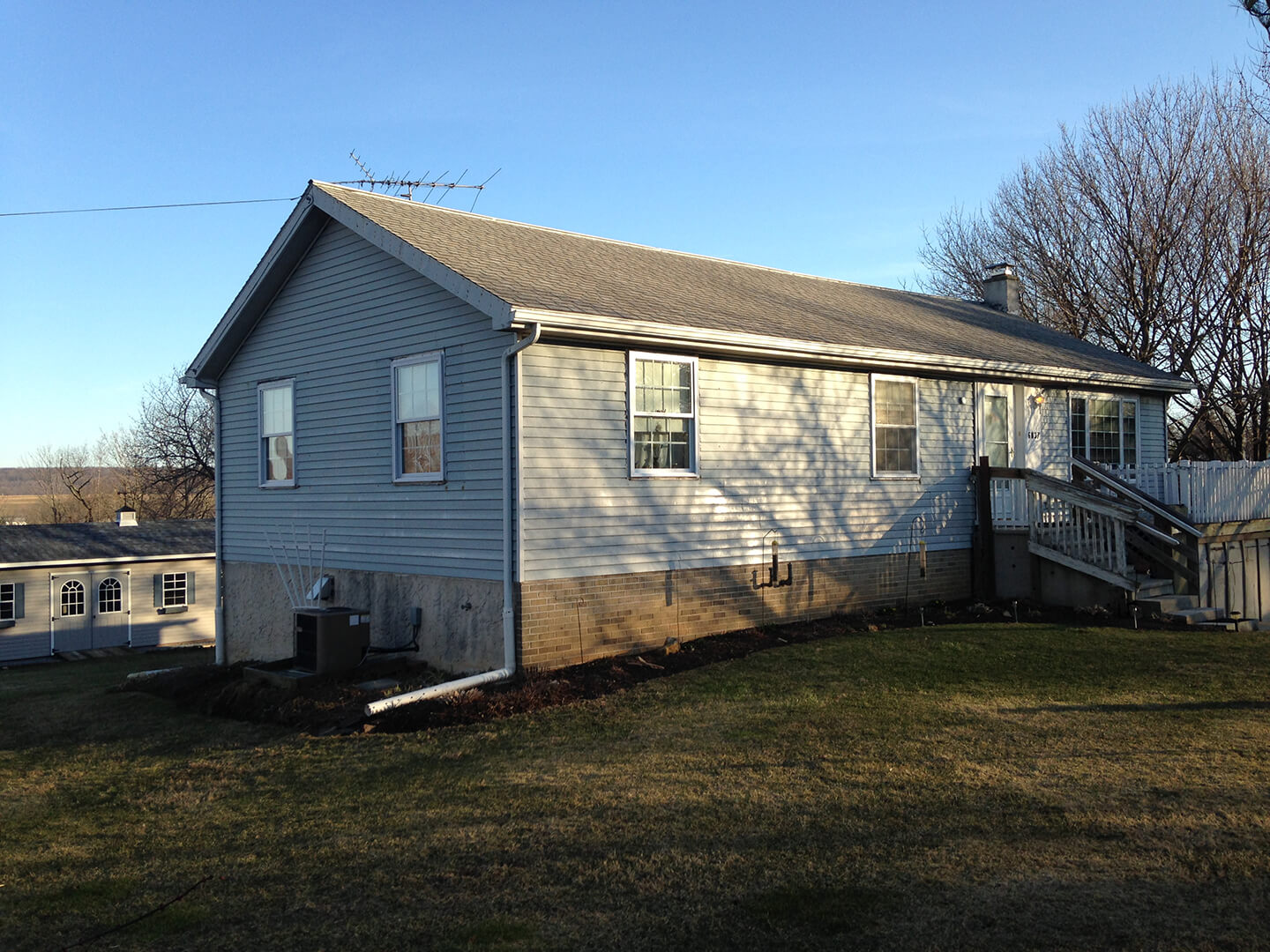 side shot of a house before its cape cod style addition