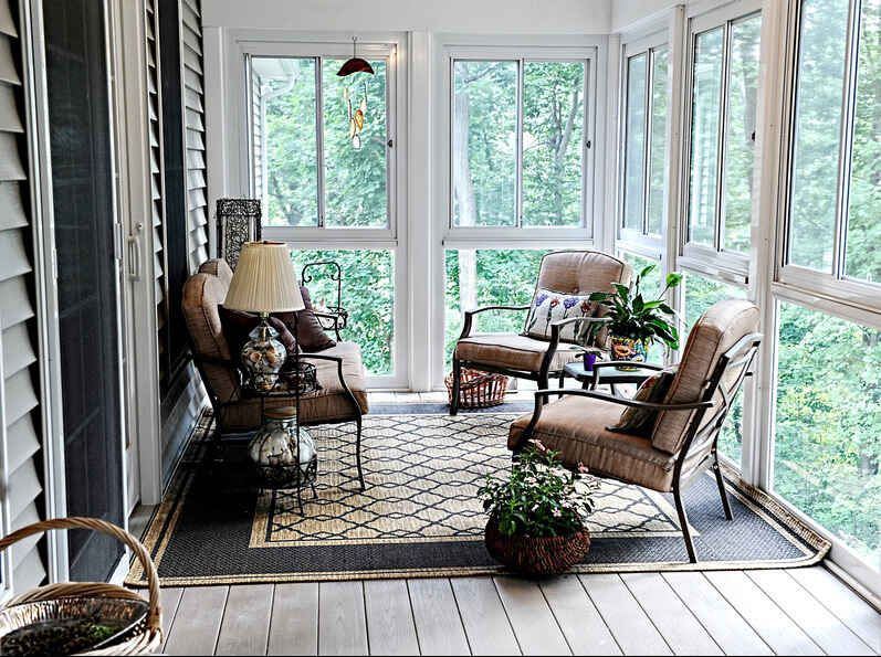 screened in porch that is fully furnished