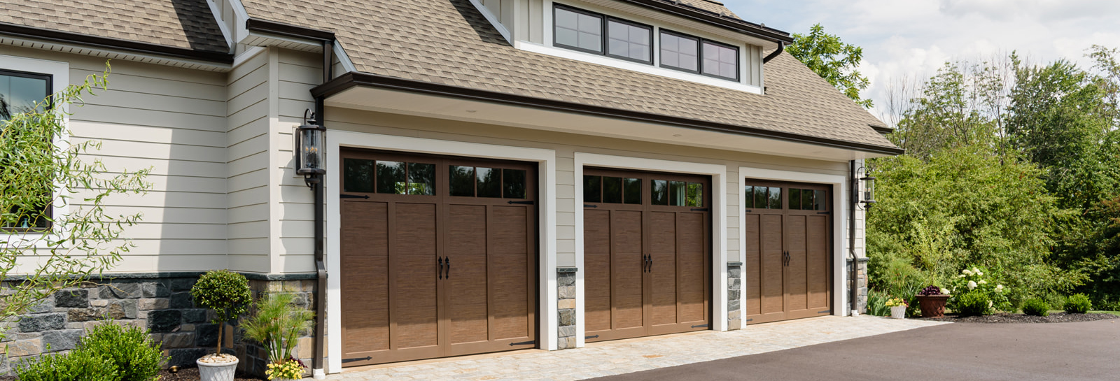 tan cape cod custom four car garage