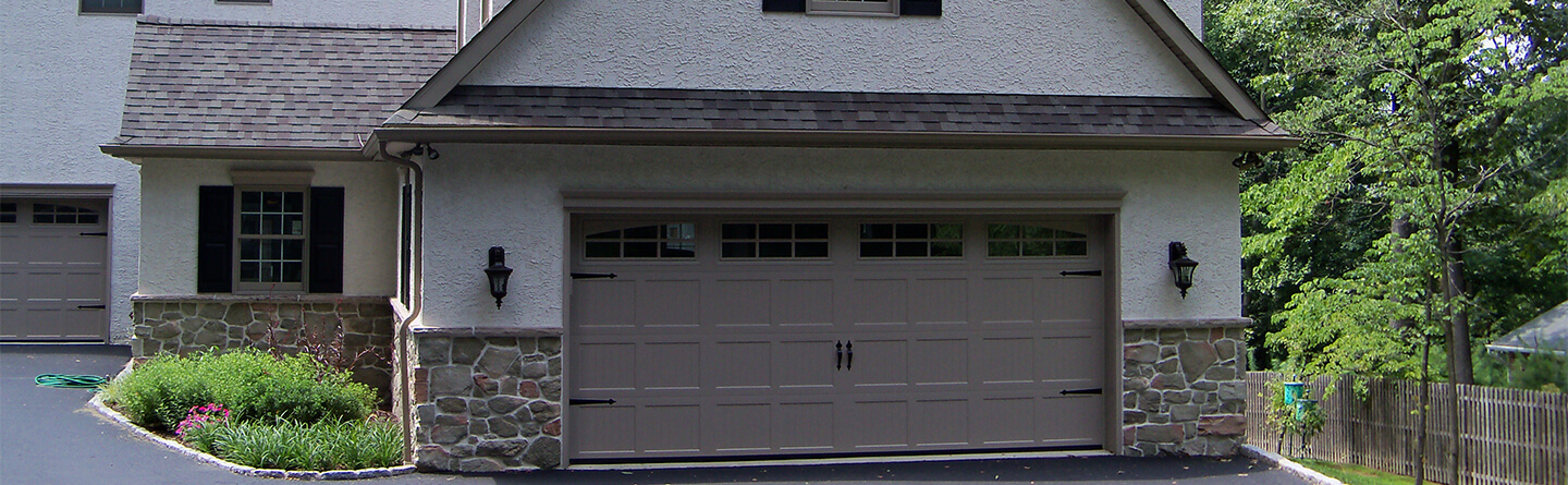 larage attached stone and stucco one car garage