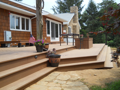 custom wooden deck on large wooden home